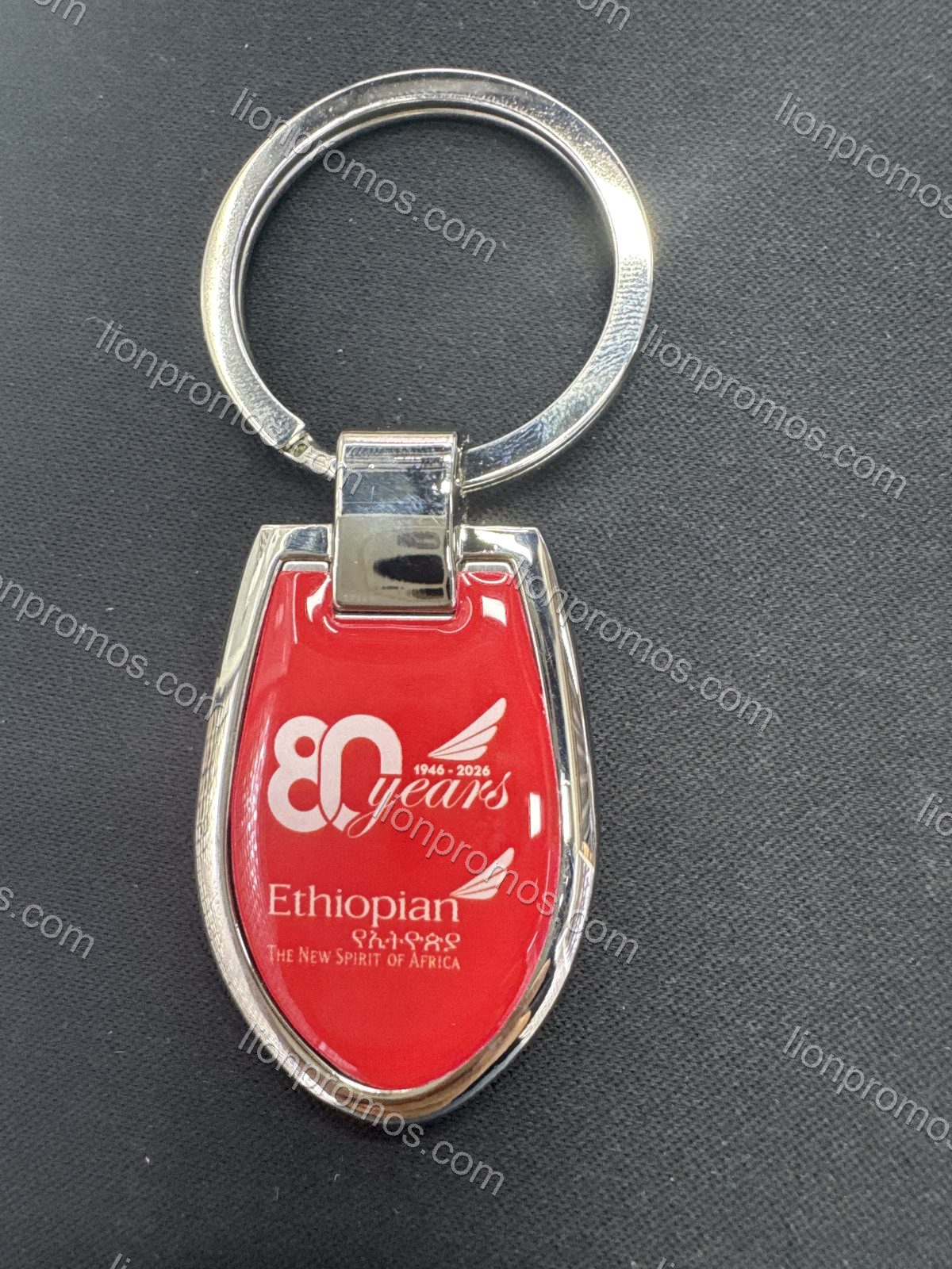 Metal keychain with epoxy dome 80th logo