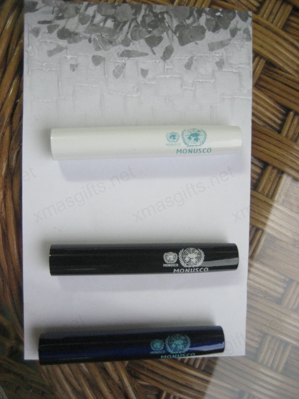 Three MONUSCO pens in white, black and dark blue