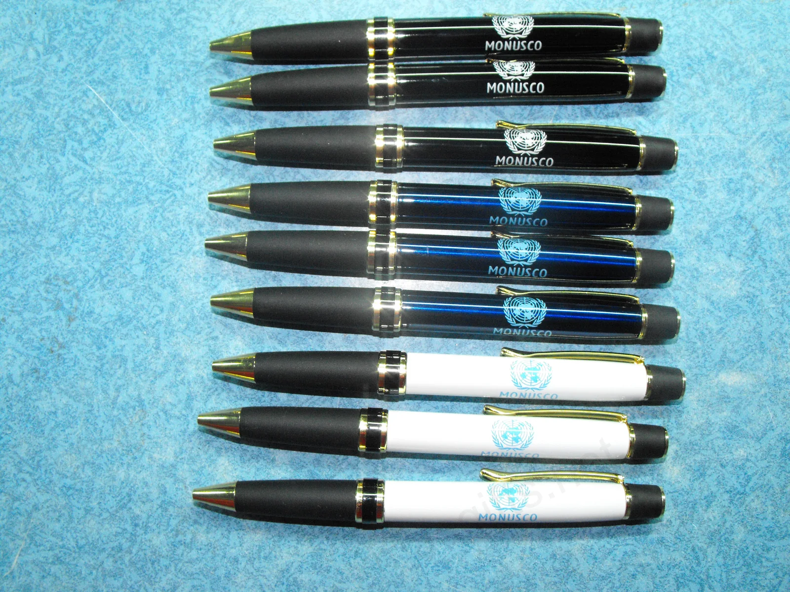 MONUSCO branded metal pens in black, blue and white