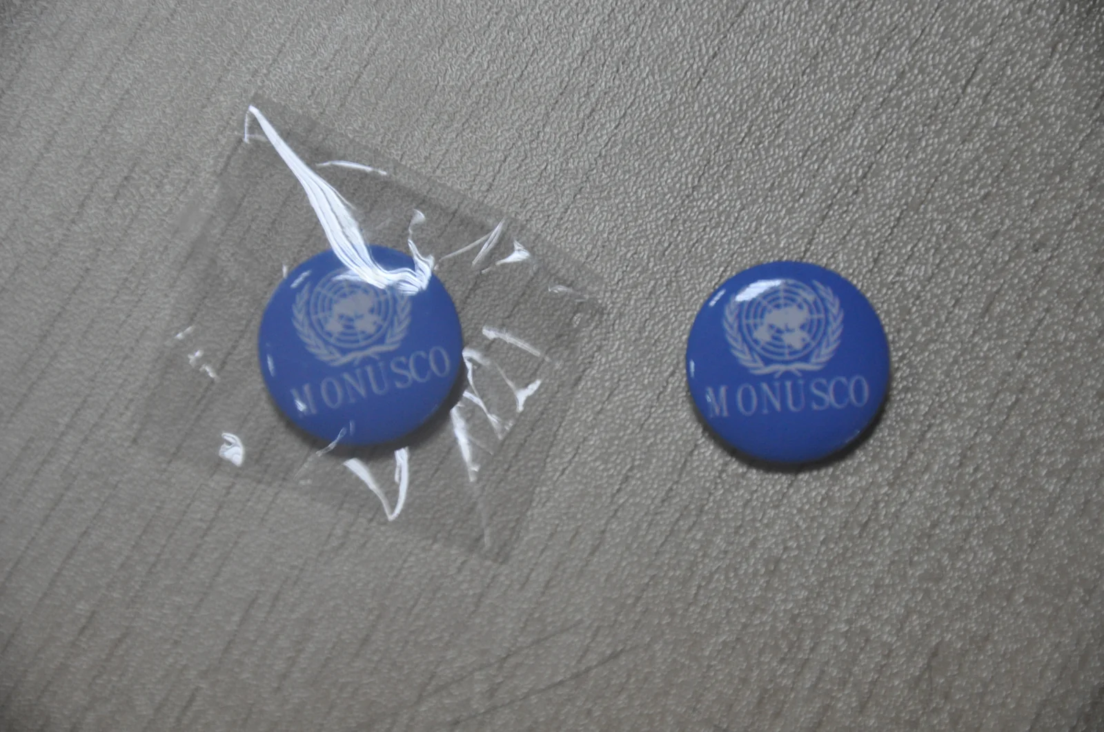 Round blue MONUSCO pin badge