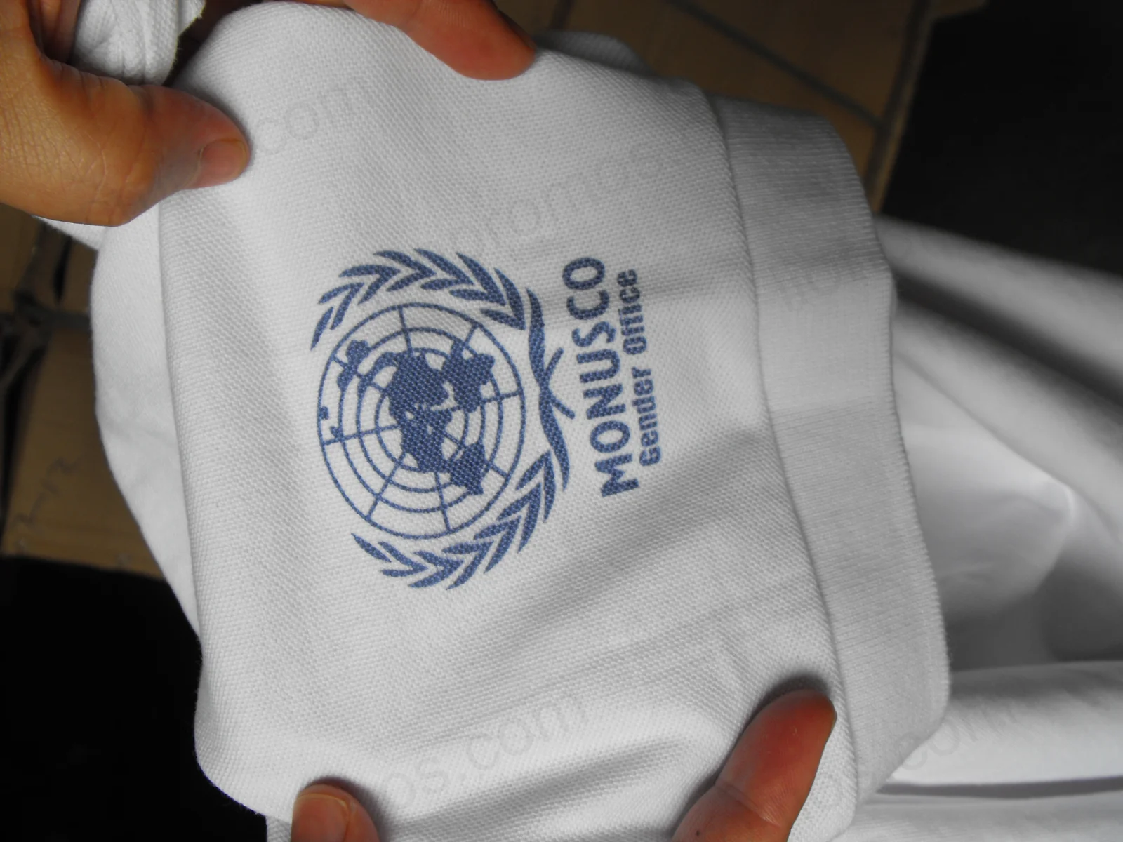 Embroidered MONUSCO Gender Office logo on polo shirt cuff