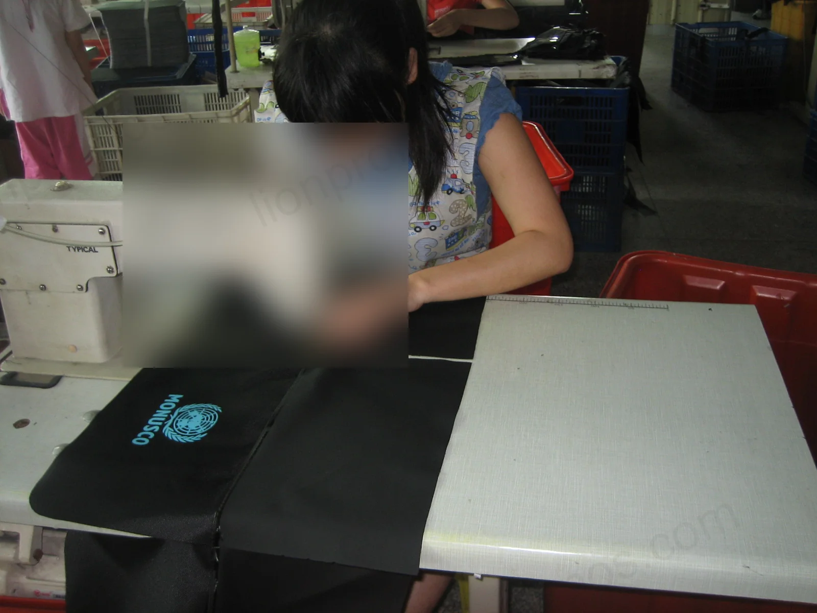 Operator sewing MONUSCO branded bag